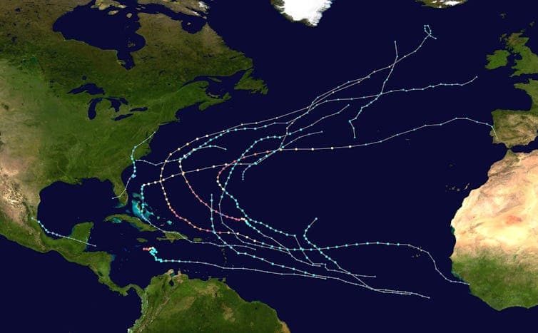 A map shows 13 storms, most starting far from the U.S. and curving off into the open Atlantic.